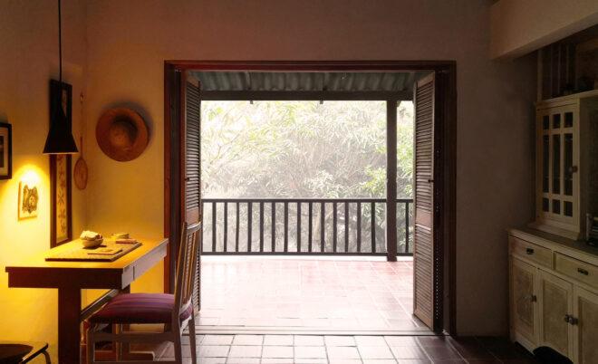 white office room with doors open to a covered patio