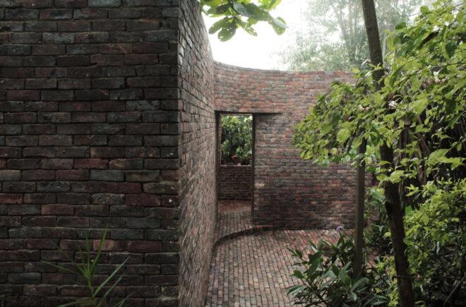 curved brick wall with large opening
