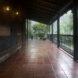long covered patio with natural tiled floors