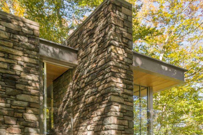 large fieldstone wall in the middle of a cabin