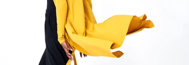 Person in black dress with yellow cardigan
