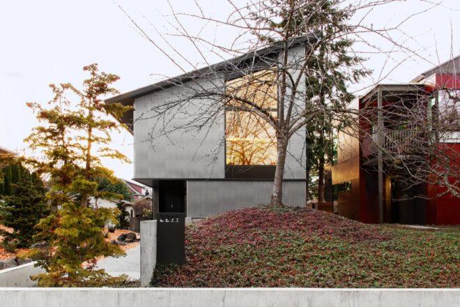 two-story gray home with slanted roof