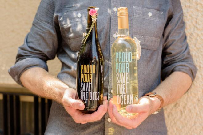 person holding two bottles of wine