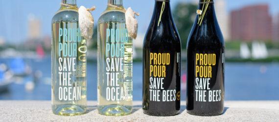 four bottles of wine on ledge near a harbor