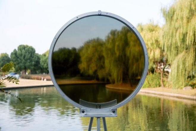 circular smog tracker device near lake