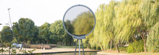 circular smog tracker device near lake with semi-transparent center