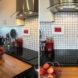 tiny kitchen with wood island and white tile backsplash