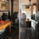 tiny kitchen with white cabinets and tiny wood island