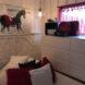 Red and white bedroom with horse art on wall