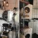 modern tiny bathroom with white tiled walls and a stacked washer and dryer