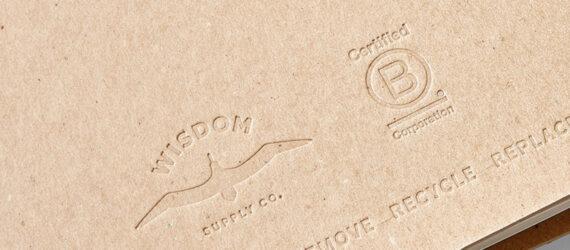 cardboard planner embossed with Wisdom Supply Co. and Certified B-Corp logos
