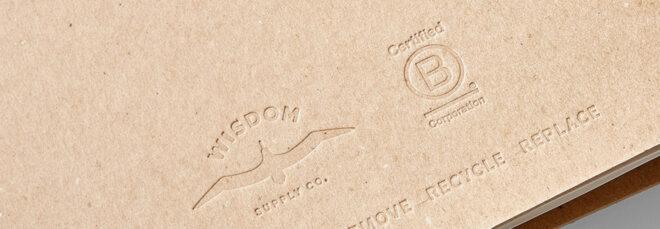 cardboard planner embossed with Wisdom Supply Co. and Certified B-Corp logos
