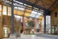 An interior shopping district made of cross-laminated timber, with brick accents.
