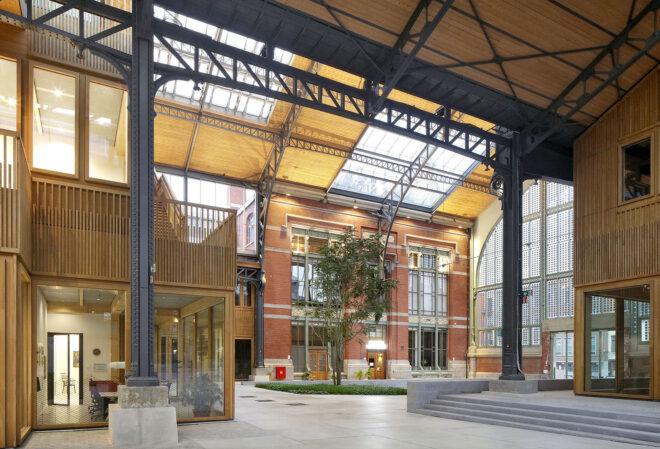 An interior shopping district made of cross-laminated timber, with brick accents.