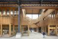 Wood staircases crossing through a timber shopping center.