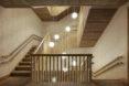 A timber stairwell with several hanging ball lights.