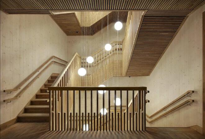 A timber stairwell with several hanging ball lights.