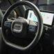 black steering wheel in an electric delivery van