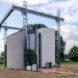A 3D-printing construction rig, with a concrete structure underneath it.