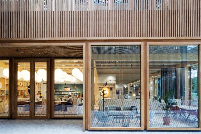 A storefront with large windows and a wood facade.