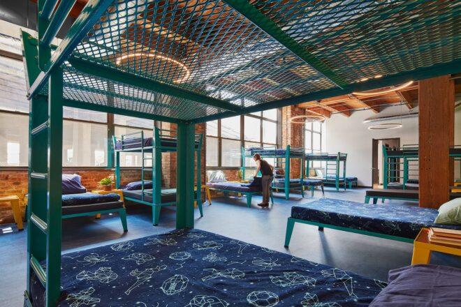 brick room with blue bunk beds