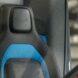 blue and black van driver's seat with Amazon logo on the headrest