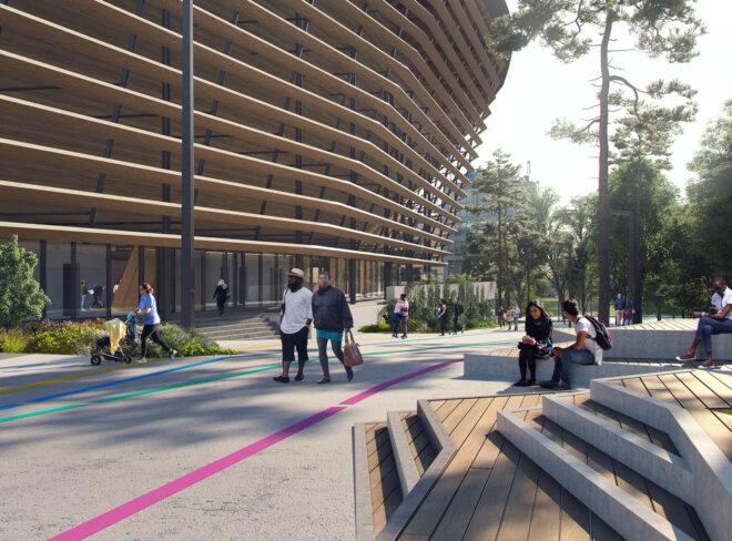 a timber structure with people strolling around on the sidewalk outside.