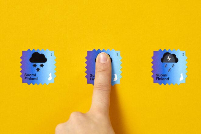three blue stamps against a yellow background. from left to right, the stamps show a snow cloud, then a person pressing their finger to the stamp, and finally the stamp showing a thunderstorm.