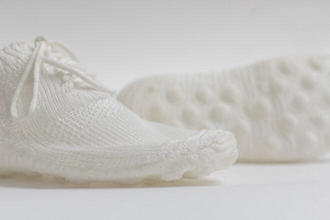 pair of white knitted shoes on white backgroun