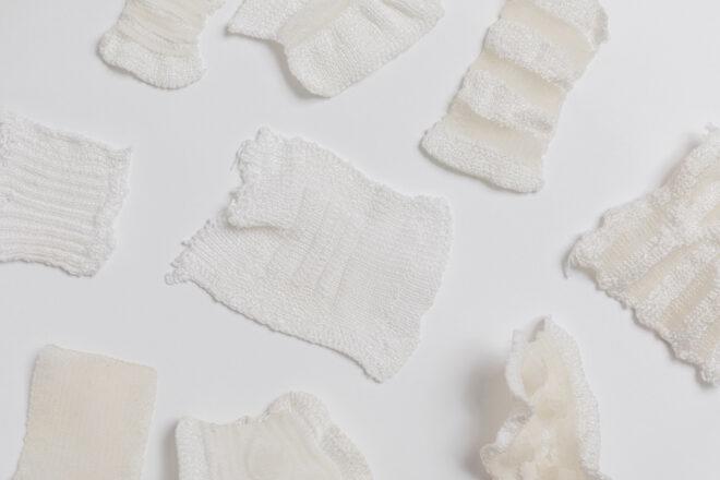 swatches of white knit fabrics on a white background