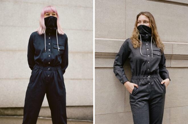 two people in gray and blue jumpsuits and wearing masks