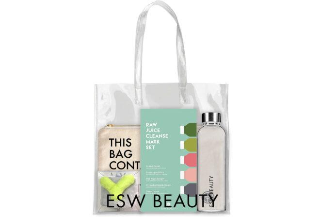 A clear tote bag reading "ESW Beauty" with a water bottle, headband, canvas bag and a pack of sheet masks inside.