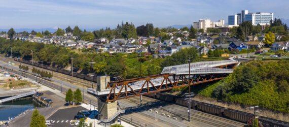aerial view of weathered steel and aluminum bridge above a highway