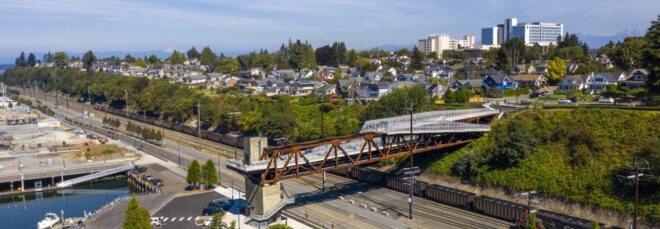 aerial view of weathered steel and aluminum bridge above a highway
