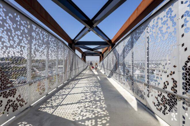 close-up of perforated aluminum guardrails on a bridge