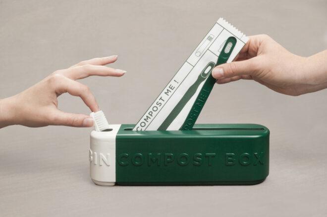 person putting toothbrush in waste box
