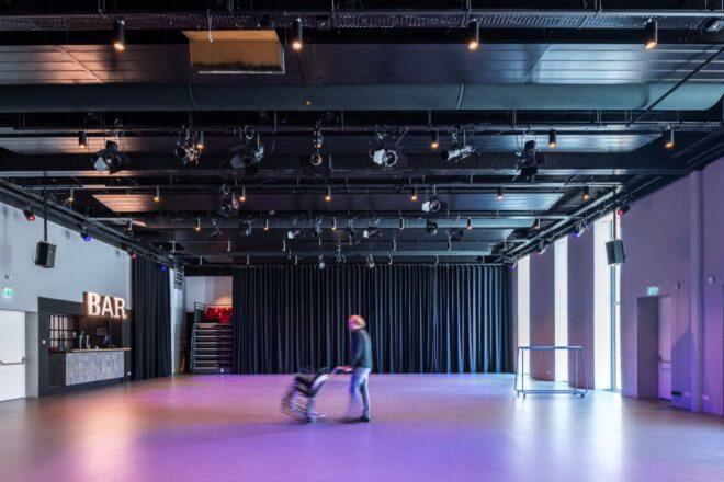 person setting up chairs in a theater