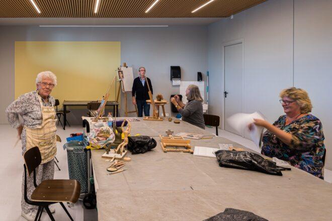 people crafting at a long work table