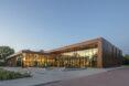 L-shaped building with glass walls at dusk