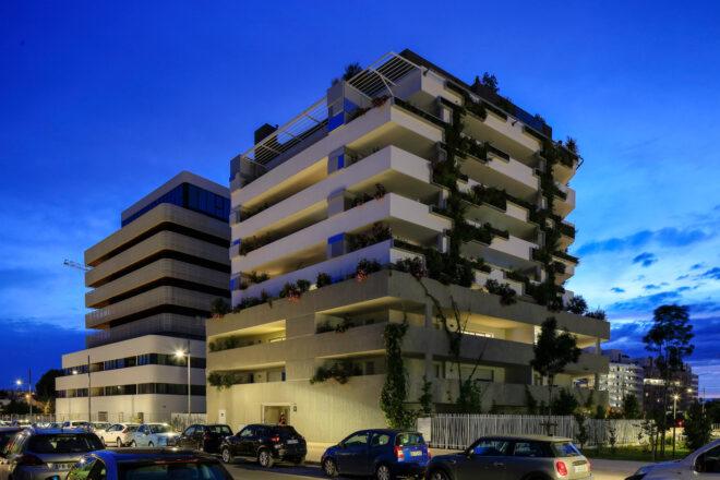 plant-covered white building at dusk