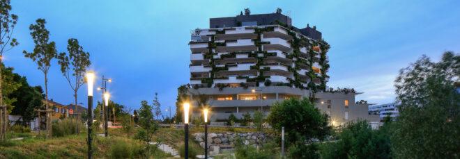 white, plant-covered building at dusk