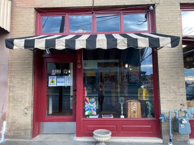 red radio station storefront with black-and-white striped awning