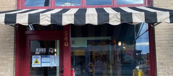 red radio station storefront with black-and-white striped awning