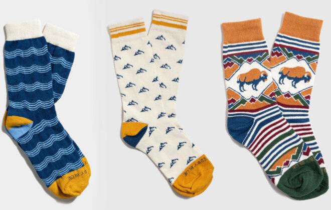 Three pairs of socks in blue, orange and cream.