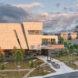 rendering of large tan building at sunset