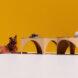 cardboard coffee tables near dog on yellow background
