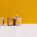 cardboard coffee tables near dog on yellow background