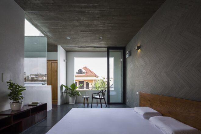 white bed in room with large square window