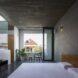 white bed in room with large square window