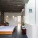 large white bed on wood bedframe in room with gray walls and ceilings